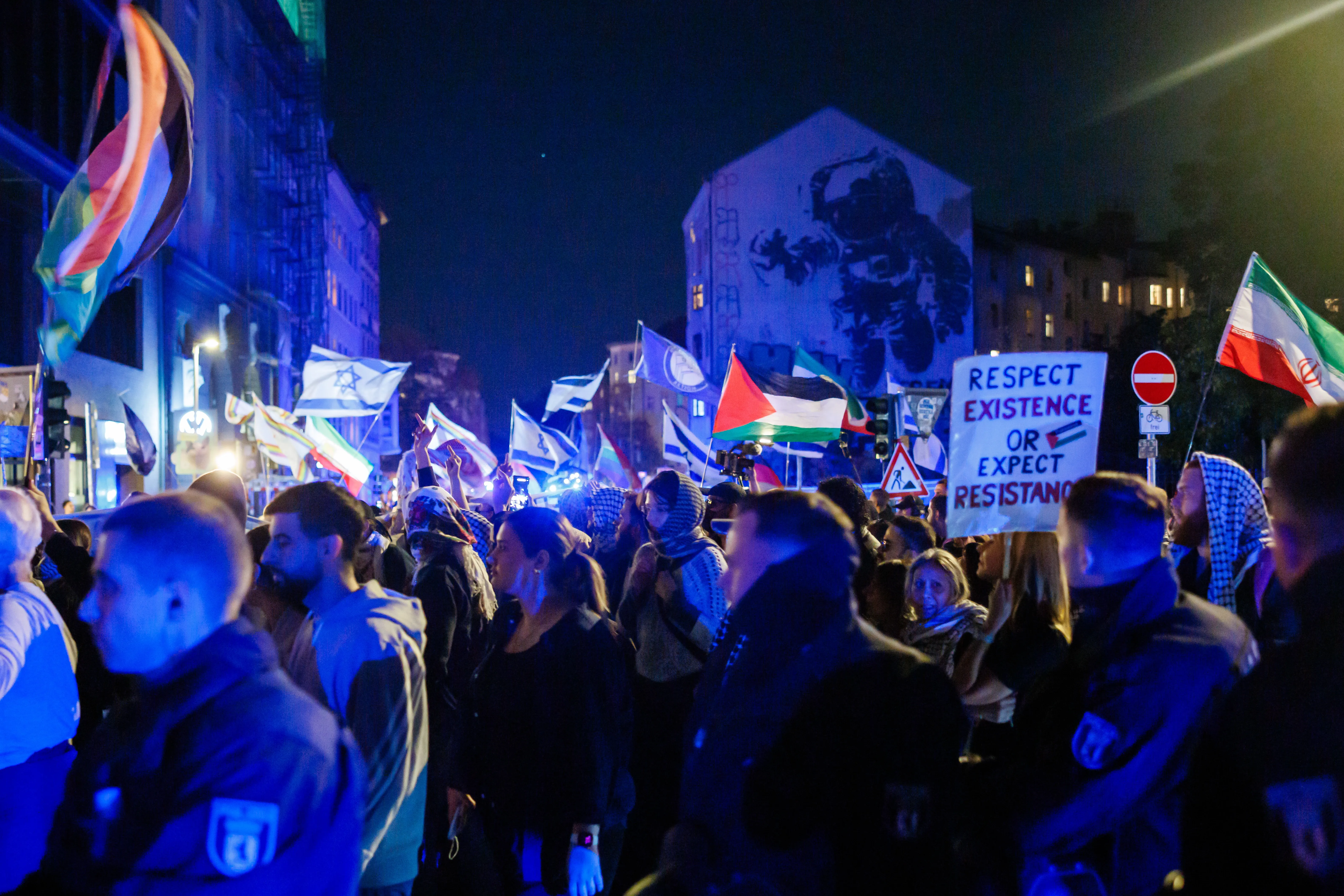 Protesters with Palestinian flags pass a counter-protest with Israeli flags in Berlin, 7 October 2026