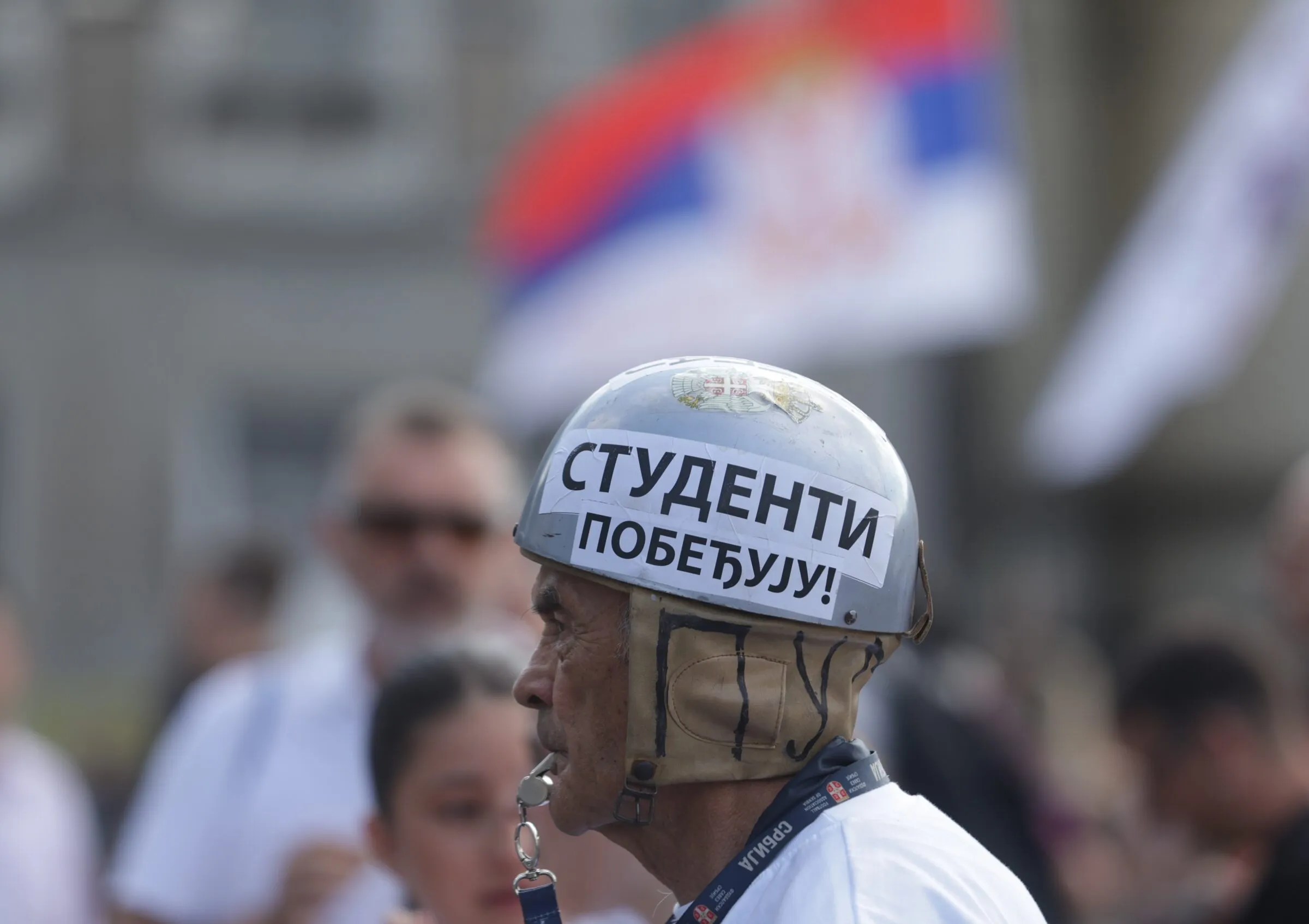 A protester shows a patch reading ‘Students are winning’ during a mass student-led anti-government rally in Belgrade. Source: EPA/Andre Cukić.